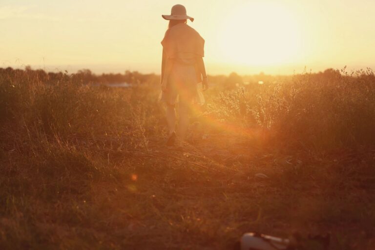 Woman walking into the sunset outdoors